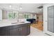 Spacious kitchen area showcases a stainless steel sink, lots of natural light, and a seamless flow to the living room at 2664 Forest St, Denver, CO 80207