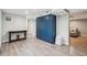 Spacious living area featuring wood-look floors, bright blue cabinets, and accent tables at 2664 Forest St, Denver, CO 80207