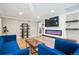 Inviting living room featuring a modern fireplace, open shelving, and stylish decor at 2664 Forest St, Denver, CO 80207