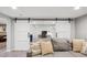 Living Room featuring an open view of the adjacent office space with sliding barn doors at 2664 Forest St, Denver, CO 80207