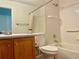 Well-lit bathroom featuring a vanity with a sink, toilet, and tiled shower-tub combination, enhanced with safety bars at 20344 Heather Ln, Parker, CO 80138