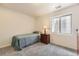 Cozy bedroom features gray carpet, a twin bed, and a wooden nightstand next to a window at 20344 Heather Ln, Parker, CO 80138