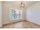 Bright dining room with modern flooring, a large window, and a stylish light fixture at 20344 Heather Ln, Parker, CO 80138