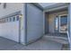 Close-up of the front entrance and garage of a single-Gathering home featuring updated light fixtures at 20344 Heather Ln, Parker, CO 80138