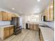 Bright kitchen featuring stainless steel appliances, oak cabinets, and open layout at 20344 Heather Ln, Parker, CO 80138