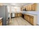 Well-lit kitchen with stainless steel appliances, wooden cabinets, and modern flooring at 20344 Heather Ln, Parker, CO 80138