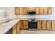 Modern kitchen with stainless steel appliances, oak cabinets, and ample counter space at 20344 Heather Ln, Parker, CO 80138