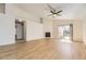 Spacious living room featuring updated flooring, a ceiling fan, and a cozy fireplace at 20344 Heather Ln, Parker, CO 80138