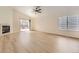 Bright living room with modern flooring, a fireplace, and a sliding glass door to the outside at 20344 Heather Ln, Parker, CO 80138