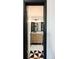 Stylish bathroom featuring a wooden vanity, black and white tile floor, and modern fixtures at 2700 S Holly St # 202, Denver, CO 80222