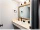 Bathroom featuring granite countertops, a large mirror and modern sink fixtures at 2700 S Holly St # 202, Denver, CO 80222