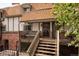 Charming townhouse exterior with brick accents, wooden deck, and inviting entrance at 2700 S Holly St # 202, Denver, CO 80222