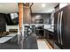 Well-equipped kitchen with black countertops, stainless steel appliances, and gray cabinets at 2700 S Holly St # 202, Denver, CO 80222