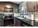 Updated kitchen with stainless steel appliances and white subway tile backsplash at 2700 S Holly St # 202, Denver, CO 80222