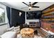 Living room with a black brick fireplace and a large screen TV at 2700 S Holly St # 202, Denver, CO 80222