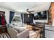 Cozy living room featuring a black brick fireplace, TV, and comfortable seating at 2700 S Holly St # 202, Denver, CO 80222