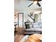 Cozy living room featuring wood floors, a modern ceiling fan and comfortable sofa at 2700 S Holly St # 202, Denver, CO 80222