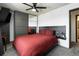 Comfortable bedroom with a spacious closet, modern ceiling fan and brick accent wall at 2700 S Holly St # 202, Denver, CO 80222