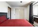Comfortable bedroom featuring a closet, a modern headboard, and a window at 2700 S Holly St # 202, Denver, CO 80222