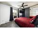 Comfortable bedroom with a spacious closet, a modern headboard, ceiling fan and window at 2700 S Holly St # 202, Denver, CO 80222