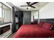 Comfortable bedroom with a spacious closet, modern ceiling fan and brick accent wall at 2700 S Holly St # 202, Denver, CO 80222