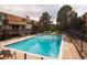 Bright community swimming pool with surrounding lounge chairs and manicured landscaping at 2700 S Holly St # 202, Denver, CO 80222