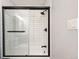 Clean, modern bathroom with a tiled shower featuring a glass door and black fixtures at 2700 S Holly St # 202, Denver, CO 80222