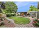Beautifully landscaped backyard featuring a lush lawn, garden beds, and mature trees at 632 Wyoming St, Golden, CO 80403