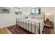 Bright bedroom with two large windows, hardwood floors, and a decorative rug at 632 Wyoming St, Golden, CO 80403
