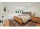 Cozy bedroom featuring natural light, hardwood floors, neutral color palette, and a unique rug at 632 Wyoming St, Golden, CO 80403