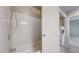 This bright bathroom has a shower-tub combo and a stacked washer/dryer at 14495 E 1St Dr # C1, Aurora, CO 80011