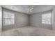 The spacious bedroom boasts two windows for natural light and neutral decor at 14495 E 1St Dr # C1, Aurora, CO 80011