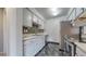 Modern kitchen featuring stainless steel appliances, mosaic backsplash, and tile flooring at 14495 E 1St Dr # C1, Aurora, CO 80011