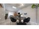 Open-concept living and dining area featuring a brick fireplace and a dining table with chairs at 14495 E 1St Dr # C1, Aurora, CO 80011