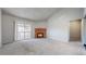 Bright living room with vaulted ceiling, brick fireplace, and sliding door access to the balcony at 14495 E 1St Dr # C1, Aurora, CO 80011