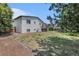 Exterior view of the home's backyard and deck, with an open lawn and fencing at 15908 E Flora Pl, Aurora, CO 80013