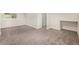 Large basement area with carpeting, bright white trim, and natural light from the window at 15908 E Flora Pl, Aurora, CO 80013