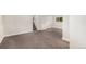 Spacious carpeted basement with painted walls, stairs to the upper level, and a bright window at 15908 E Flora Pl, Aurora, CO 80013