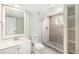 Basement bathroom featuring updated vanity and tiled shower with a tiled floor at 15908 E Flora Pl, Aurora, CO 80013