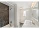 Modern bathroom featuring a shower with black accent tile and a sink with quartz countertop at 15908 E Flora Pl, Aurora, CO 80013