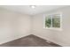 Clean bedroom featuring soft carpeting and bright natural lighting through the window at 15908 E Flora Pl, Aurora, CO 80013
