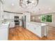 Modern kitchen with white cabinets, stainless steel appliances, and a spacious center island at 15908 E Flora Pl, Aurora, CO 80013
