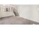 Bright living area featuring neutral carpeting and stairs leading to other levels of the home at 15908 E Flora Pl, Aurora, CO 80013