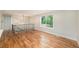 Open-concept living area featuring gleaming hardwood floors and large picture window at 15908 E Flora Pl, Aurora, CO 80013