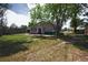 Backyard view featuring lush greenery, privacy fencing, and the back of the residence at 5942 Poplar St, Commerce City, CO 80022
