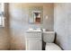 Tiled bathroom featuring a vanity, toilet and mirror at 5942 Poplar St, Commerce City, CO 80022