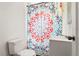 Bathroom featuring a colorful shower curtain, toilet and sink at 5942 Poplar St, Commerce City, CO 80022