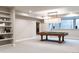 Basement rec room featuring a pool table and built-in shelving, perfect for entertainment and relaxation at 295 Jersey St, Denver, CO 80220