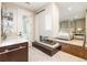 Elegant bathroom with a modern fireplace separating the bath area from the bedroom at 295 Jersey St, Denver, CO 80220