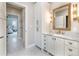 Charming bathroom with marble countertop, custom cabinets, and a decorative mirror at 295 Jersey St, Denver, CO 80220